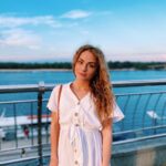 photo of the author, Anna Lysiuk, in front of bright blue water