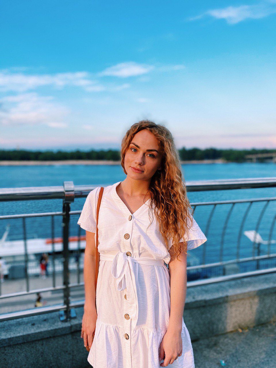photo of the author, Anna Lysiuk, in front of bright blue water