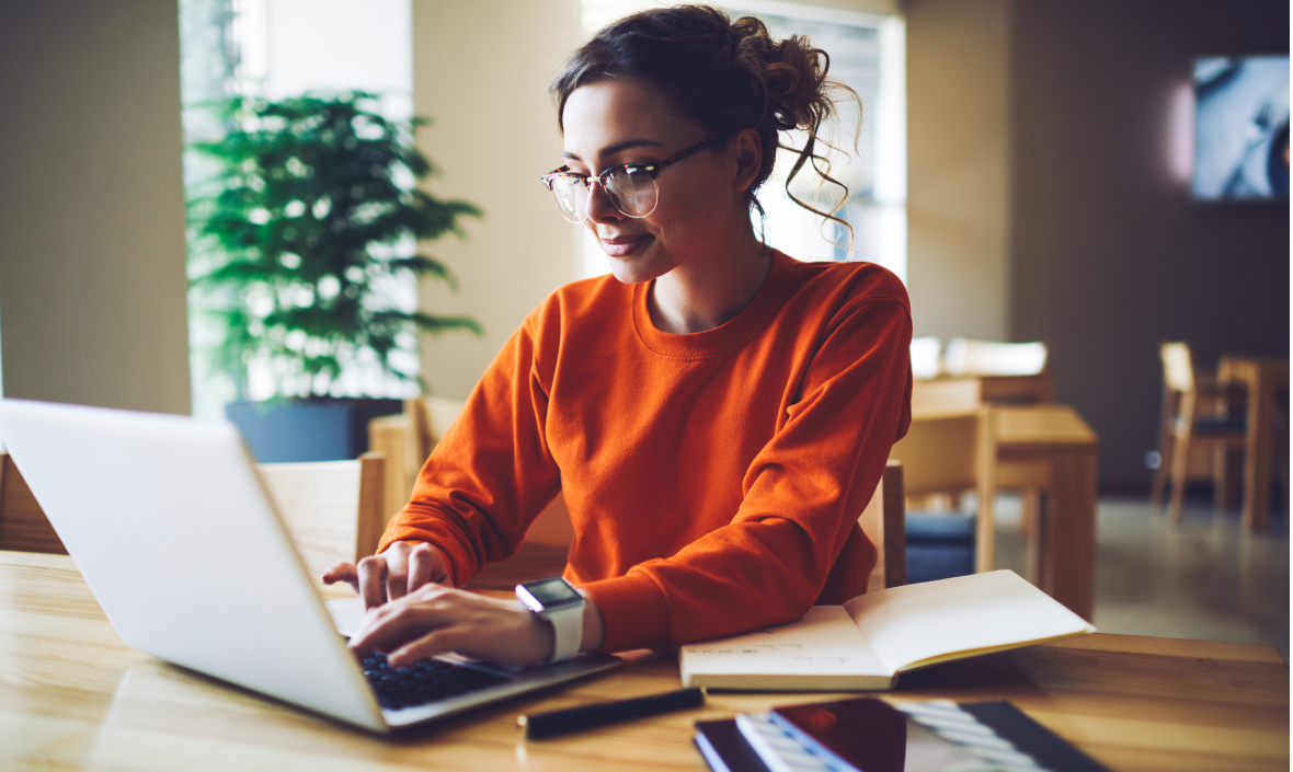photo of a young woman at a laptop doing research